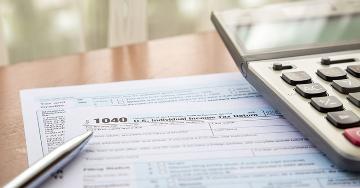 tax-forms-on-desk-with-pen-and-calculator_360x188