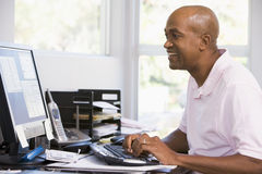 man-home-office-using-computer-smiling-5539687